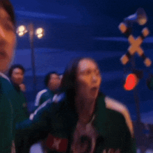a person wearing a green jacket with the number 2 on the front