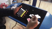 a person is holding a calculator with the number 16 on the screen