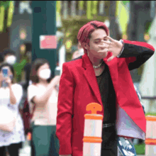 a man with red hair wearing a red jacket