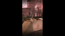 a man is holding a sword in front of a screen that says " a maison des mains "