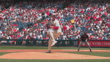a philadelphia phillies pitcher winds up to throw a pitch