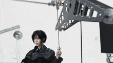 a woman in a black leather jacket is standing in front of a sign that says s.m.