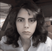 a black and white photo of a woman making a face