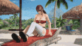 a woman in a bikini sits on a lounge chair on a beach
