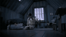 a little girl is sitting on the floor in a room with #crypttv written on the bottom of the screen
