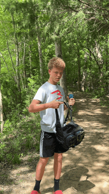 a young boy holding a bag and a can of soda