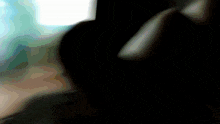 a close up of a person 's hand holding a cell phone in the dark