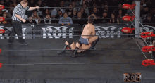 a wrestling match with the word roh on the bottom right