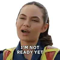 a woman says i 'm not ready yet while wearing a safety vest