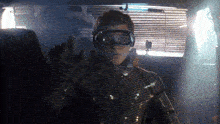 a man in a futuristic suit is wearing a pair of virtual reality glasses