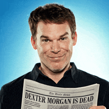 a man holding a newspaper that says " dexter morgan is dead "