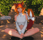 a girl with orange hair and a red tail is sitting on a wooden deck