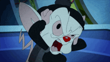 a cartoon mouse with a black hat is covering his face with his hand