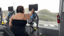a woman riding an elliptical machine with the word ne on the side