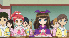 a group of children are sitting in a classroom with one girl wearing a bat costume