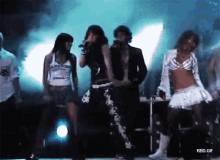 a group of people are dancing on a stage with a watermark that says rbd.gif on the bottom