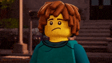 a lego figure with brown hair and a blue shirt smiles