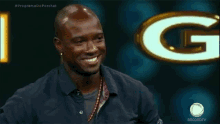 a man is smiling in front of a sign that says recordtv on it