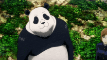 a panda bear is standing in the grass with a woman