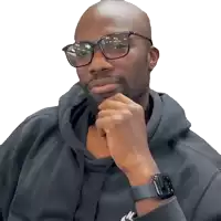 a man wearing glasses and a nike watch looks at the camera