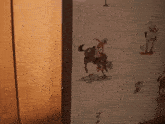a cowboy riding a horse on a wall with other cowboys