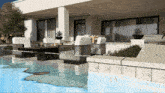 a rendering of a house with a pool and chairs