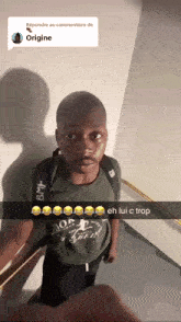 a man in a green shirt is standing in a hallway with a snapchat caption that says eh lui c trop on it