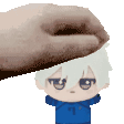 a pixel art of a hand putting a stuffed animal on a boy 's head .