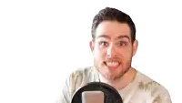 a man with a beard is giving a thumbs up in front of a microphone