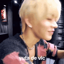 a close up of a person 's face with the words yuta de vic written below it