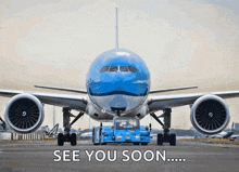 an airplane is being towed on a runway with the words see you soon