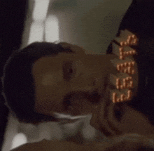 a close up of a person 's face with a sign that says ' l.d. ' on it