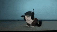 a cartoon dog wearing headphones and a hat is crawling on the ground .