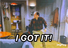 a man in a plaid shirt says " i got it " in a room
