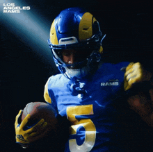 a football player for the los angeles rams is holding a ball