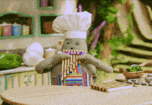 a stuffed animal is wearing a chef 's hat and apron and playing a flute