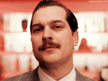 a close up of a man with a mustache and the words cgatayyfanclub