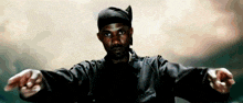 a man with his arms outstretched is wearing a black headband