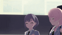 a girl with purple hair and a girl with pink hair are sitting next to each other