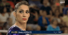 a female gymnast named daniele hypolito is on a television screen