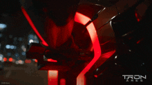 a poster for tron ares shows a motorcycle wheel