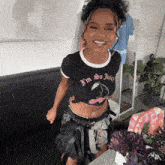 a woman wearing a black shirt that says " i 'm so juicy "