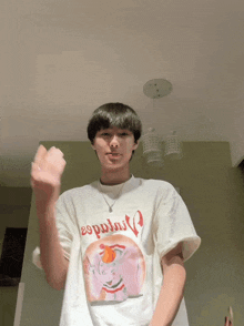 a young man wearing a white t-shirt that says " espuelas " on it