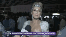 a woman with a crown on her head is talking into a microphone on sbt