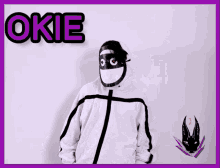 a person wearing a mask and a hoodie with the word okie on the bottom