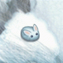 a blue bunny with pink ears is sitting on top of a snowy mountain .