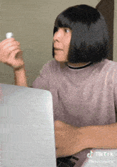 a person is sitting in front of a laptop with a tiktok watermark