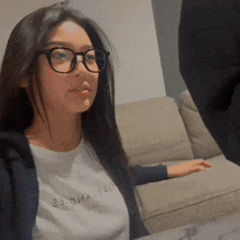 a woman wearing glasses and a white shirt that says 23 on it