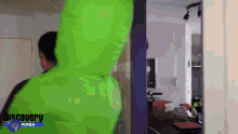 a man in a green discovery pimba hoodie