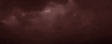 a dark red background with a blurred texture